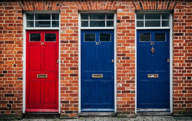 3 colourful doors on a street in Canterbury.